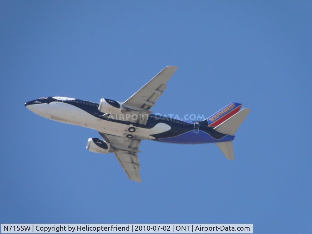 N715SW, 1998 Boeing 737-7H4 C/N 27849, Flying over runway 26R, wheels still retracted, headed out westbound