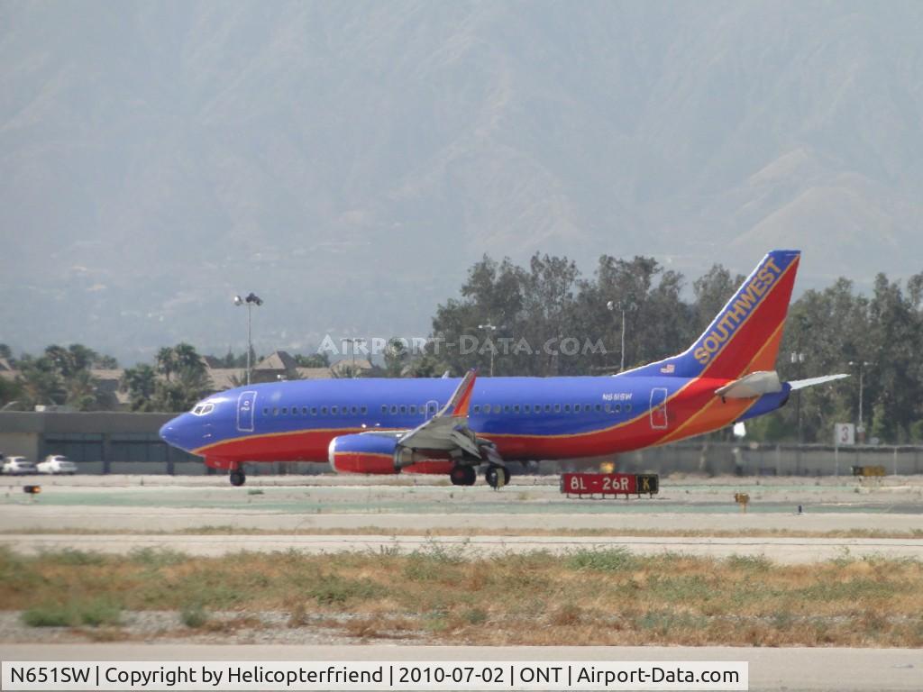 N651SW, 1997 Boeing 737-3H4 C/N 27721, Just rolled out from landing on runway 26R and is turning off to taxi back to terminal
