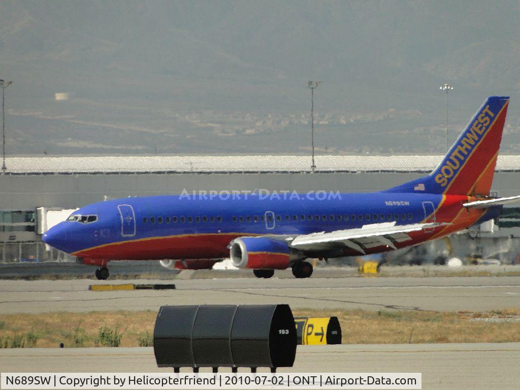 N689SW, 1985 Boeing 737-3Q8 C/N 23387, Just rolled out from landing on runway 26R and is preparing to taxi back to terminal
