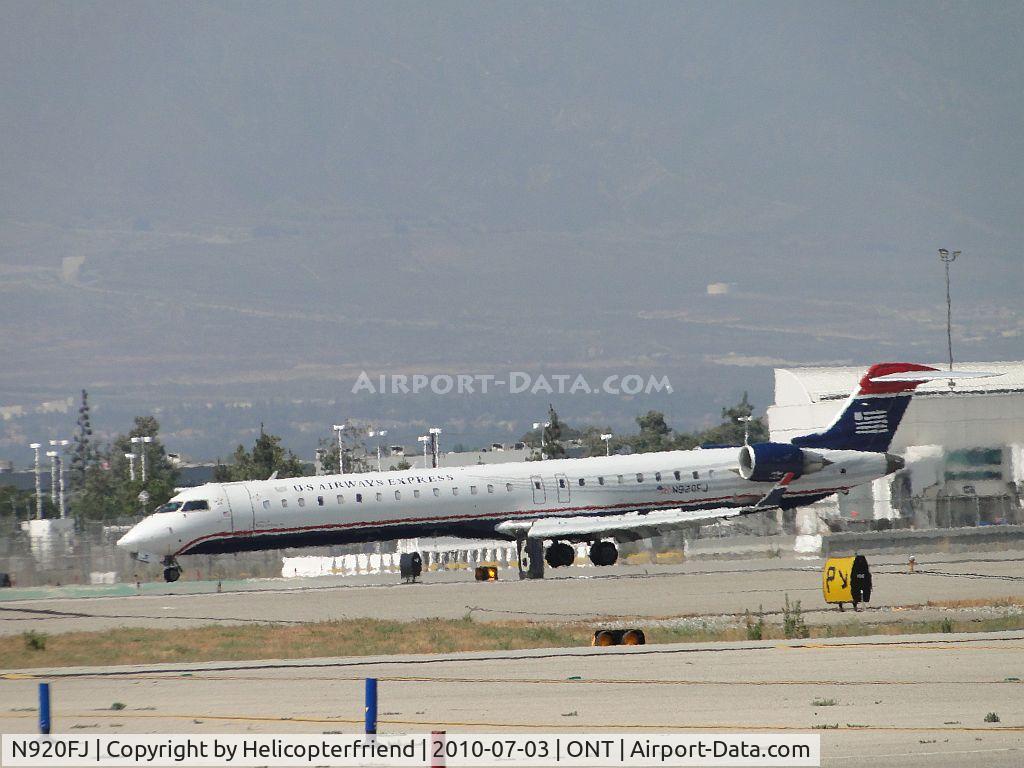N920FJ, 2004 Bombardier CRJ-900ER (CL-600-2D24) C/N 15020, Rolling out from landing on 26R and beginning to taxi back to terminal
