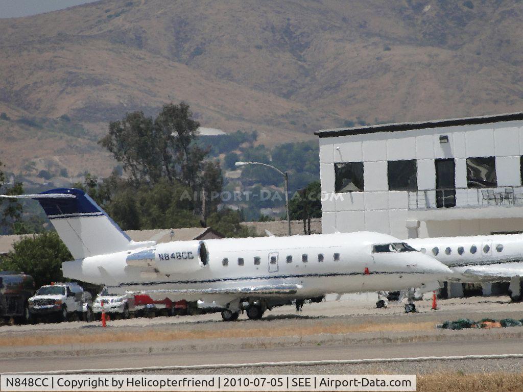 N848CC, 2006 Bombardier Challenger 604 (CL-600-2B16) C/N 5660, Parked across and north of runway 27R, heat rolling up off the runways