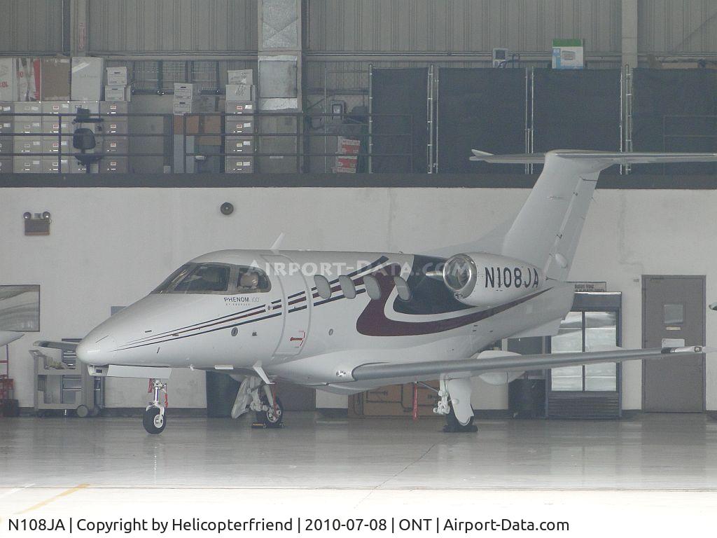 N108JA, 2009 Embraer EMB-500 Phenom 100 C/N 50000023, Parked in the hanger on a gloomy morning