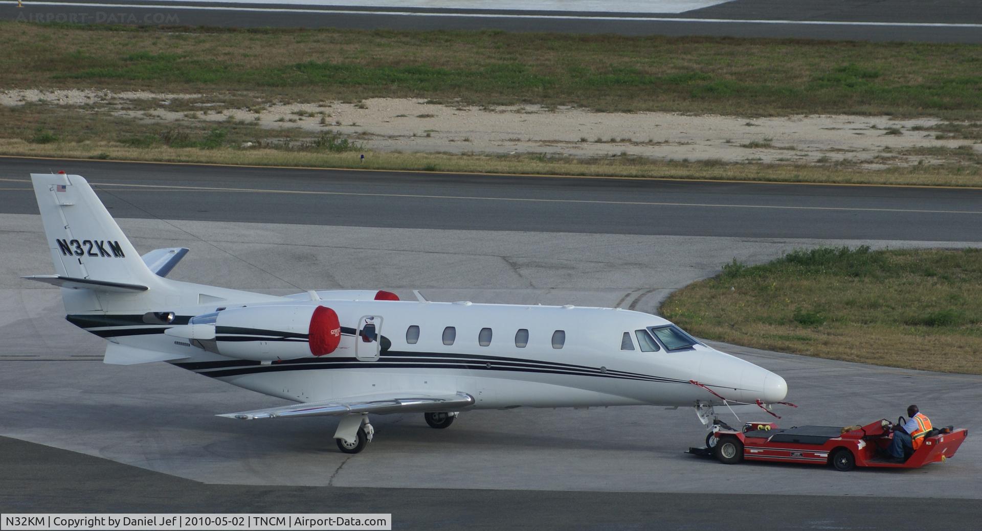 N32KM, 2007 Cessna 560XL C/N 560-5715, N32KM being push to it's parking place on the cargo ramp at TNCM