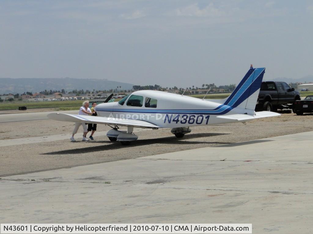 N43601, 1974 Piper PA-28-140 Cruiser C/N 28-7425381, Pushing the plane into a parking stall while other ships were being readied for flight