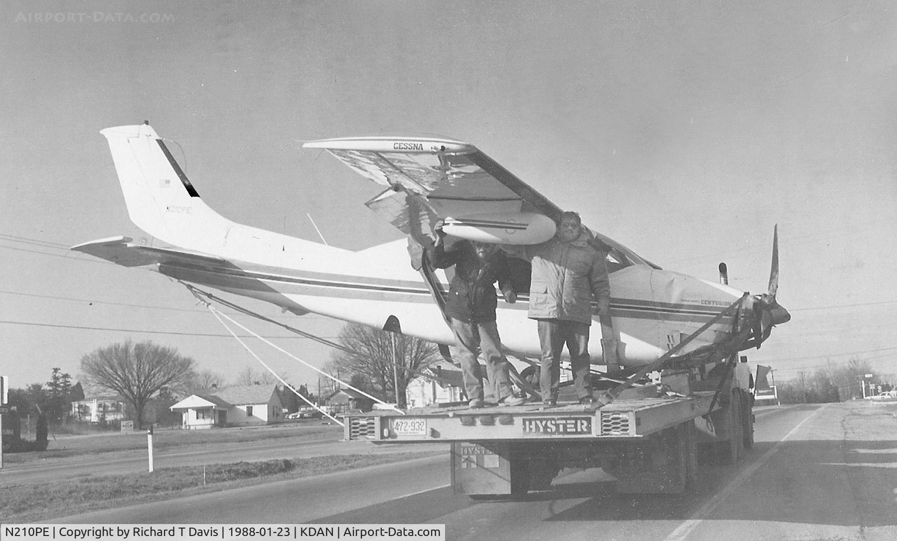 N210PE, 1969 Cessna 210J Centurion C/N 21059180, N210PE 1969 Cesna 210PE moves along on a trailer on 58 East back to KDAN ...it had crashed Jan. 21,1988 about 2 miles from the airport after it ran out of fuel..NTSB  BFO88LA015...thats Mike Rembold of General Aviation at right on the back...