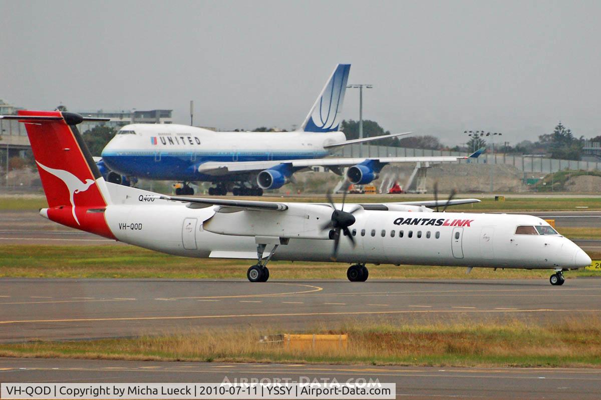 VH-QOD, 2006 De Havilland Canada DHC-8-402Q Dash 8 C/N 4123, N117UA in the background