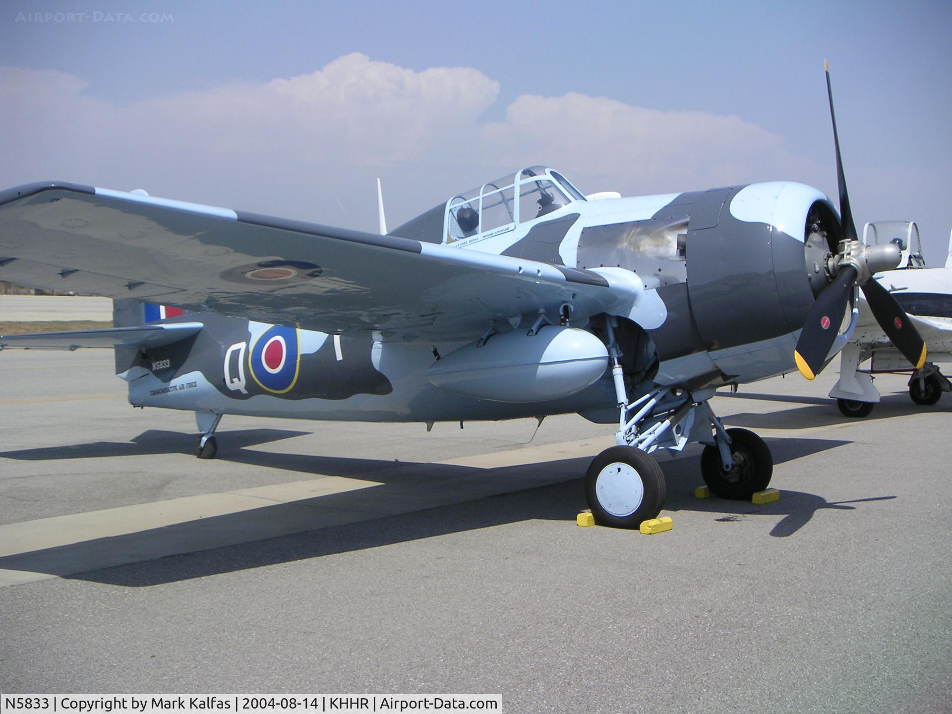 N5833, 1945 General Motors (Grumman) FM-2 Wildcat C/N 5833, Grumman FM-2 (F4F-8) Wildcat,  N5833 (c/n 5877 / BuNo 86819) on the ramp at Air Faire 2004 KHHR.