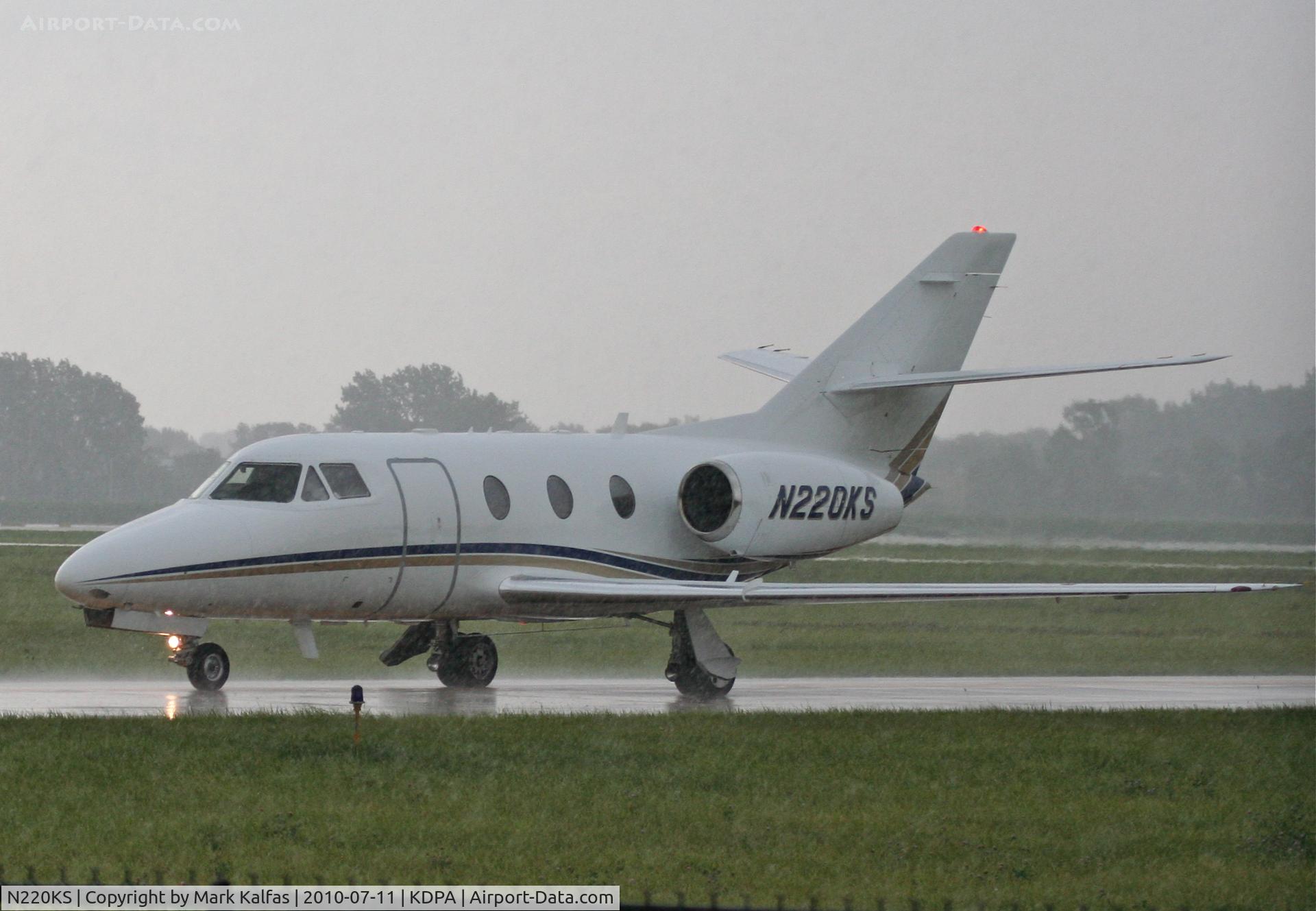 N220KS, 1984 Dassault Falcon 10 C/N 71, T M D F LLC Dassault-breguet FALCON 10, on taxiway R6 KDPA after arriving in heavy showers.