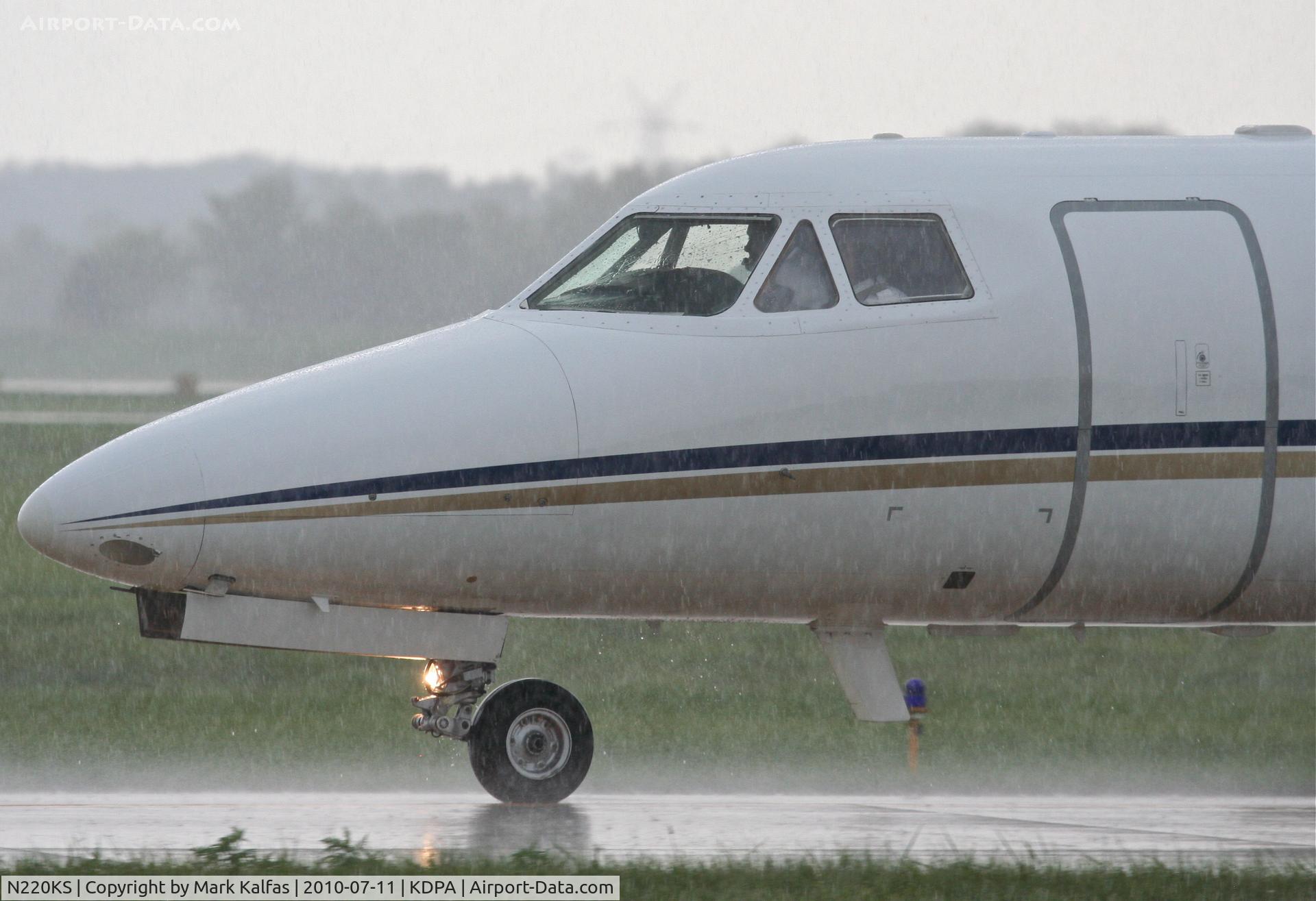 N220KS, 1984 Dassault Falcon 10 C/N 71, T M D F LLC Dassault-breguet FALCON 10, on taxiway W6 KDPA after arriving in heavy showers.