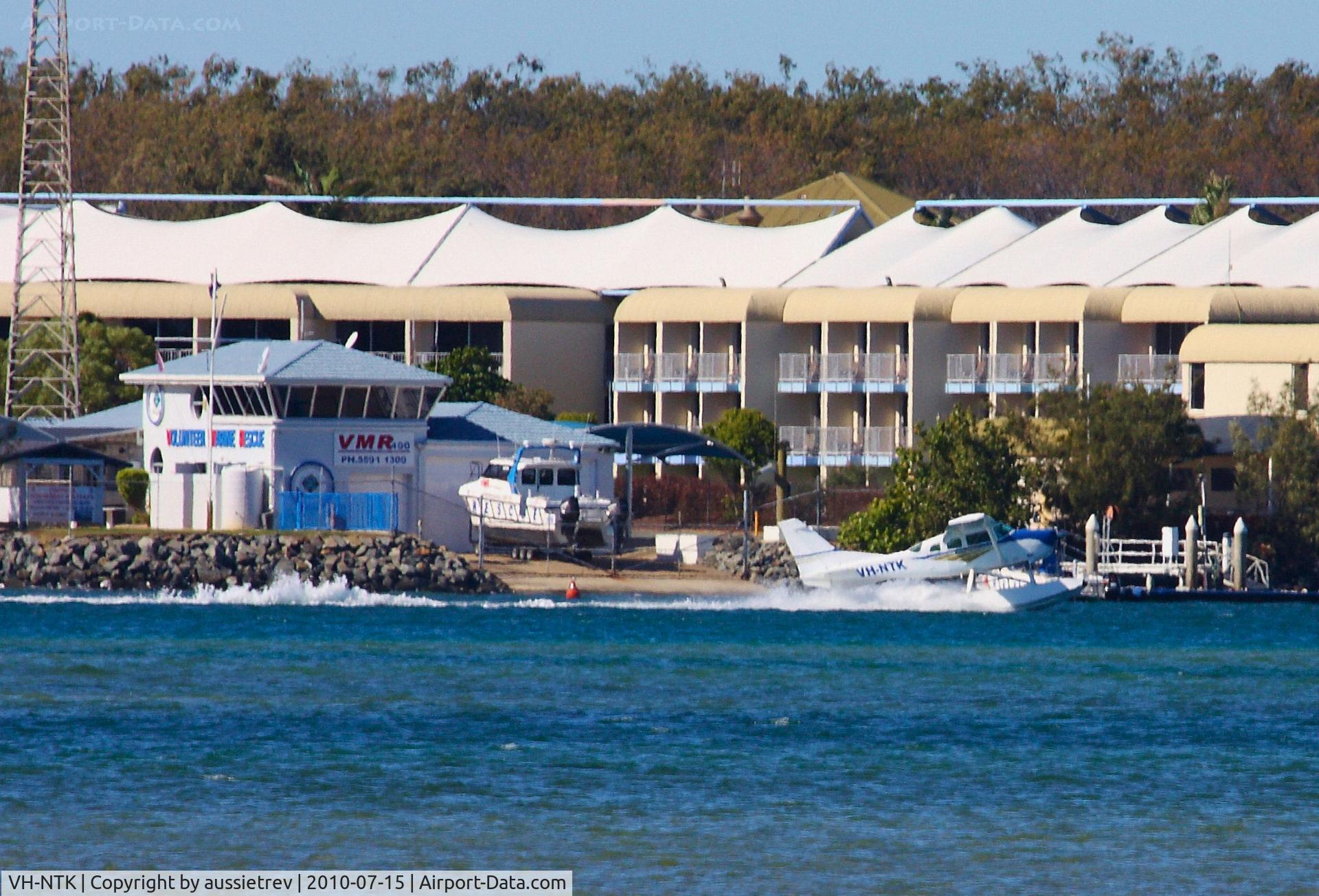 VH-NTK, 1980 Cessna U206G Stationair C/N U20605862, This aircraft is currently used for joy flights and sight seeing around the Southport Seaway on the Gold Coast, Queensland. Here it is landing out front of the Volunteer Marine Rescue base on the Southport Spit.