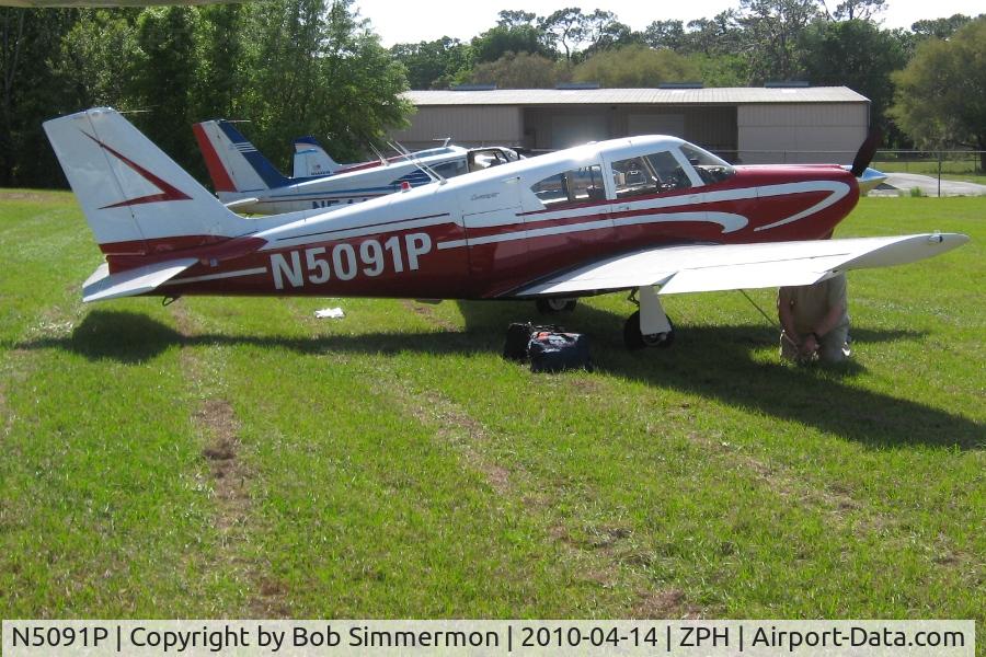 N5091P, 1958 Piper PA-24 C/N 24-100, Tied down in the grass at Zephyrhills, Florida