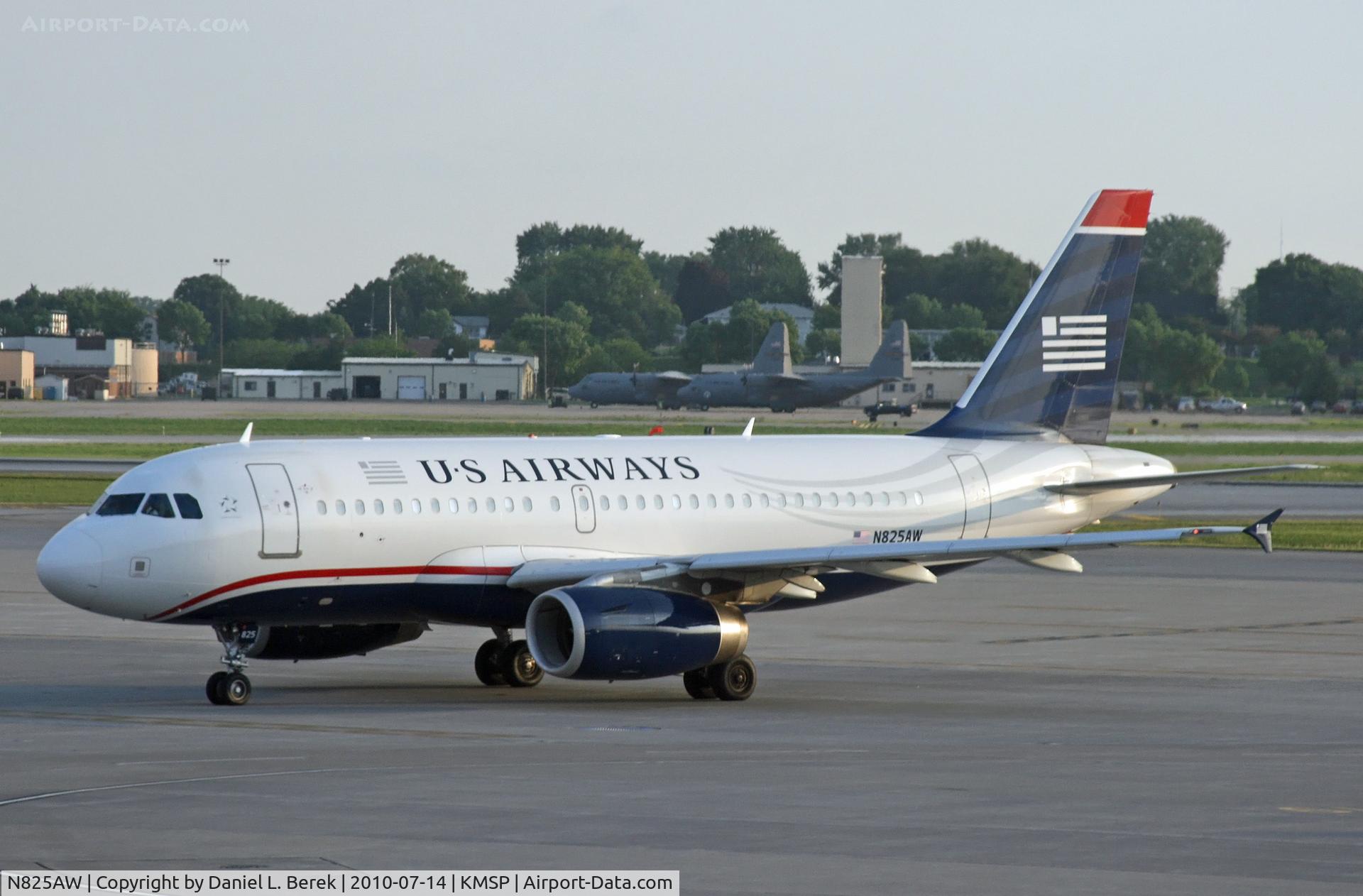 N825AW, 2001 Airbus A319-132 C/N 1527, A former America West A319, now in US Airways colors, pulls up at MSP; the Herks in the background belong to the Minnesota ANG.
