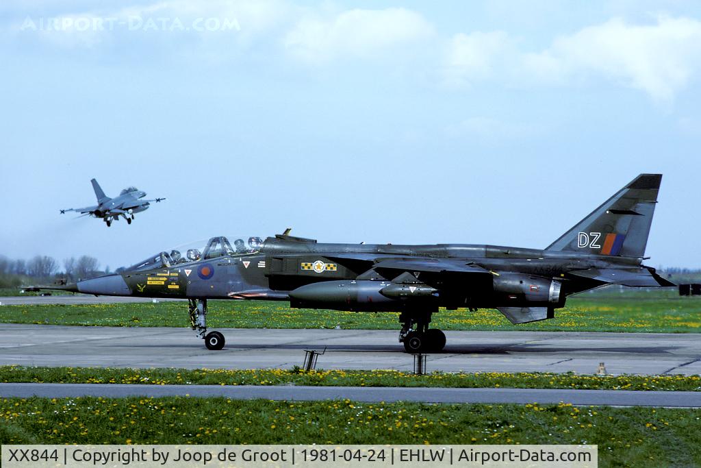XX844, 1975 Sepecat Jaguar T.2 C/N B.32, This Brüggen based 31 Sq Jaguar paid a visit to Leeuwarden. One of the local F-16s makes a low approach in the background.