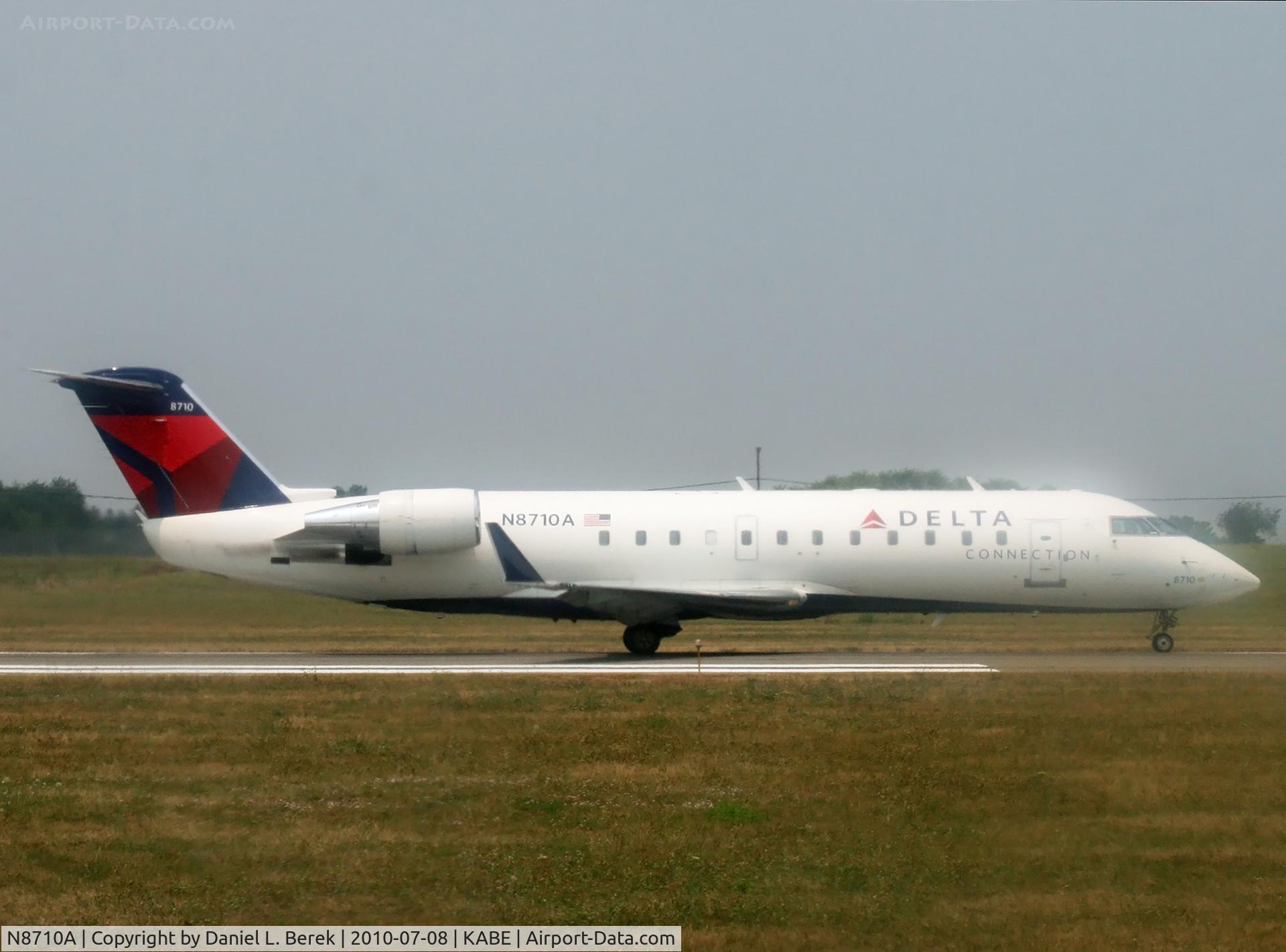 N8710A, 2002 Bombardier CRJ-200 (CL-600-2B19) C/N 7710, A regional jet usually spotted out West, makes its away on a very muggy summer morning at LVIA.