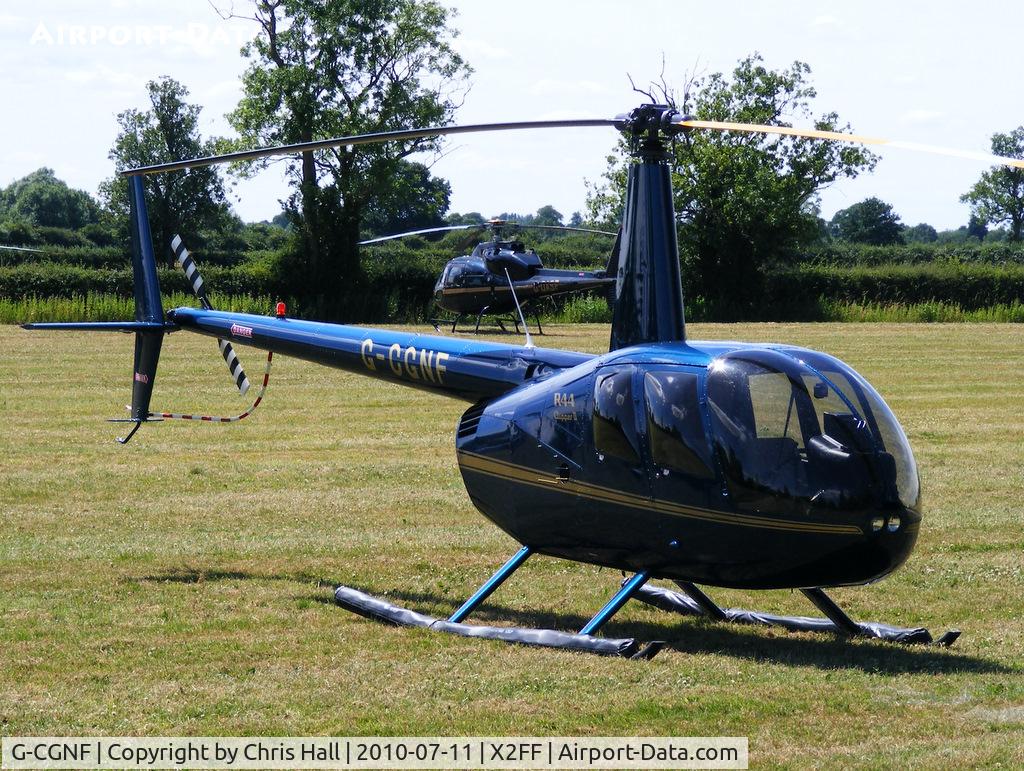 G-CGNF, 2010 Robinson R44 Clipper II C/N 13027, Robinson R44 being used for ferrying race fans to Silverstone for the British Grand Prix from this temporary heliport a few miles east of Bicester