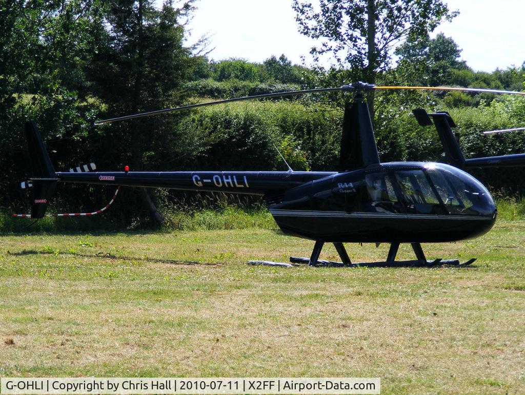 G-OHLI, 2005 Robinson R44 Clipper II C/N 10832, Robinson R44 being used for ferrying race fans to Silverstone for the British Grand Prix from this temporary heliport a few miles east of Bicester