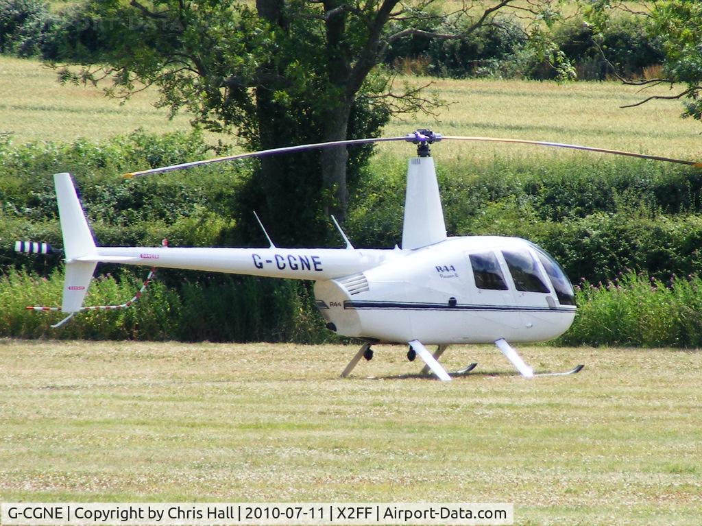 G-CGNE, 2010 Robinson R44 Raven II C/N 12952, Robinson R44 being used for ferrying race fans to Silverstone for the British Grand Prix from this temporary heliport a few miles east of Bicester
