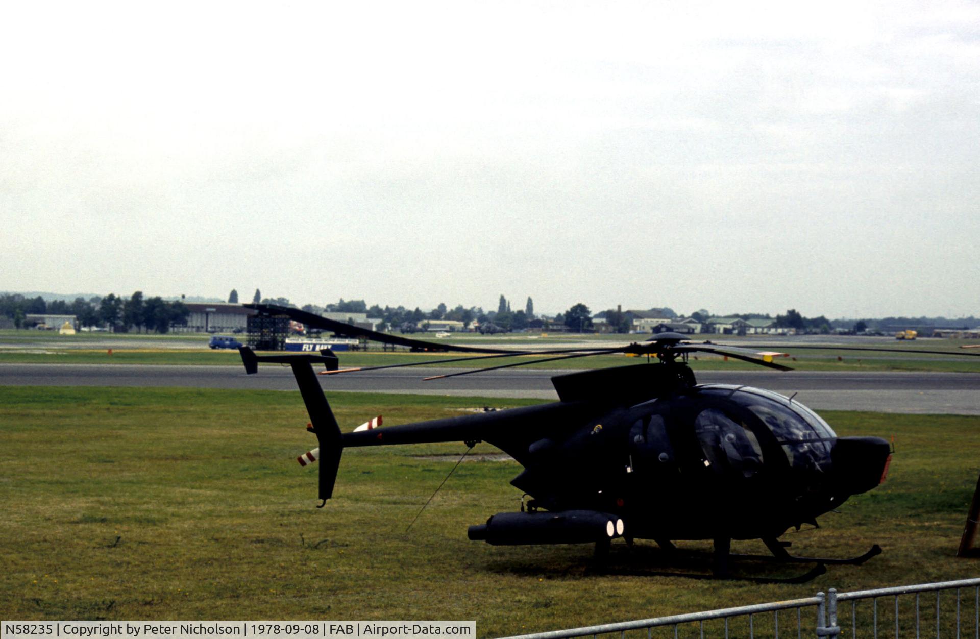 N58235, Hughes 500MD Defender (369MD) C/N 75-0323D, Hughes 500MD Defender on the flight-line at the 1978 SBAC Farnborough Airshow.