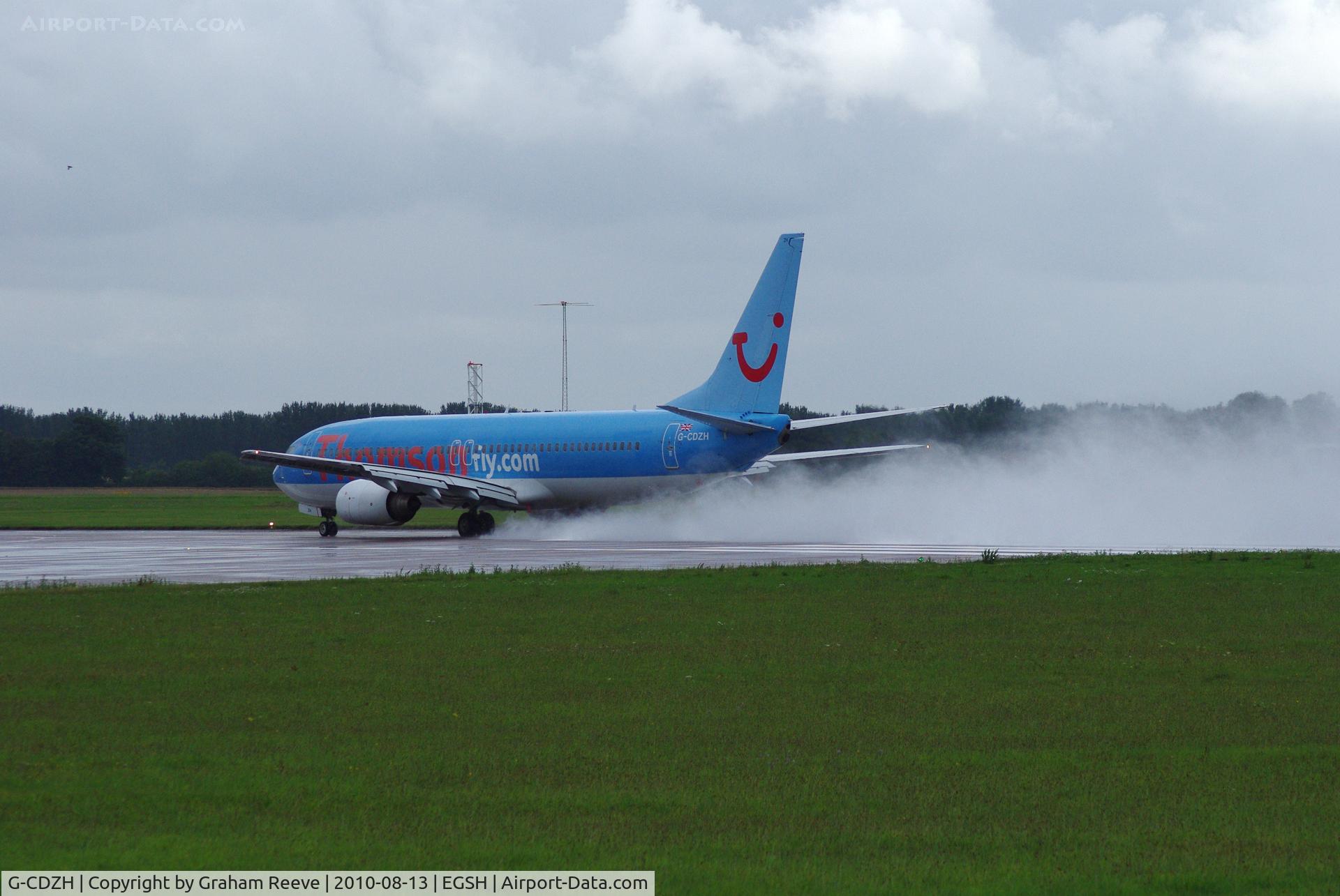 G-CDZH, 1999 Boeing 737-804 C/N 28227, Kicking up spray on a wet take off.