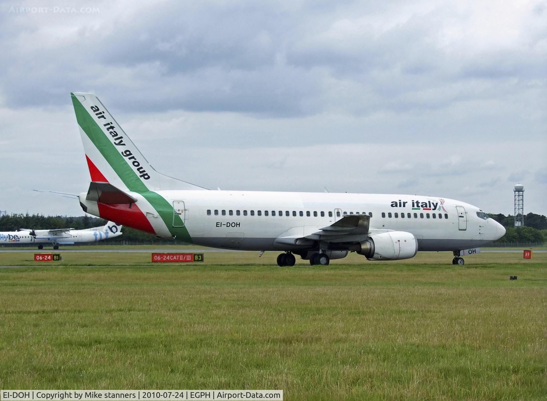 EI-DOH, 1997 Boeing 737-31S C/N 29056, Air italy B737 Arrives at EDI With Dash 8 G-ECOD In the back ground landing on runway 24