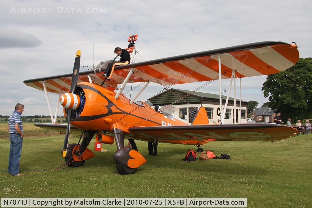 N707TJ, 1943 Boeing A75N1(PT17) C/N 75-950, Boeing PT-17 Kaydet being re-fuelled by the 'wing walker' at Fishburn Airfield in July 2010.