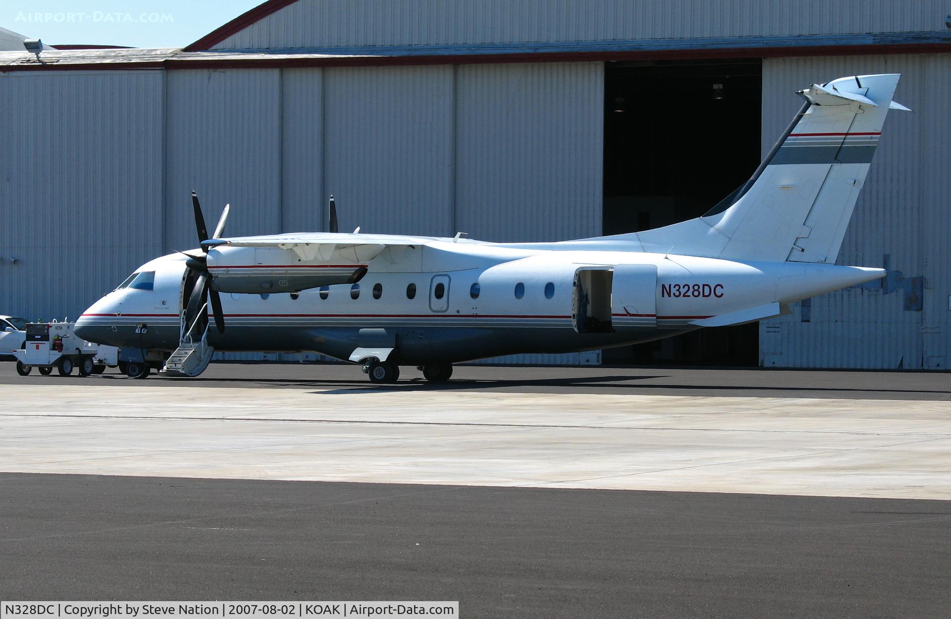 N328DC, 1994 Dornier 328-100 C/N 3019, Locally-based 1994 Dornier Luftfahrt Gmbh 328-100 outside hangar at KOAK on North Field ramp