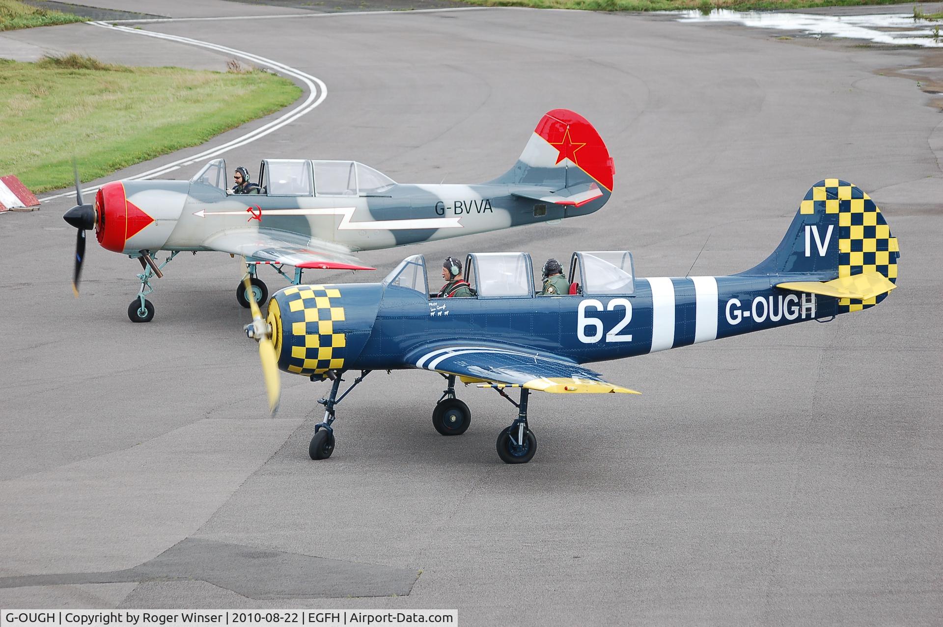 G-OUGH, 1987 Bacau Yak-52 C/N 877404, On the apron with G-BVVA.Marked 74/JA on starboard side.