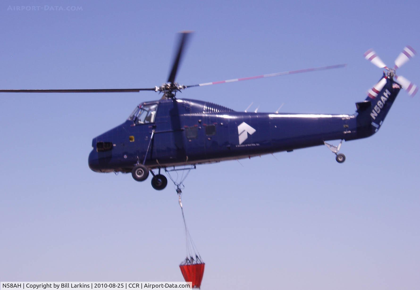 N58AH, 1956 Sikorsky S-58ET C/N 58-328, On the way to the fire with the water bucket.