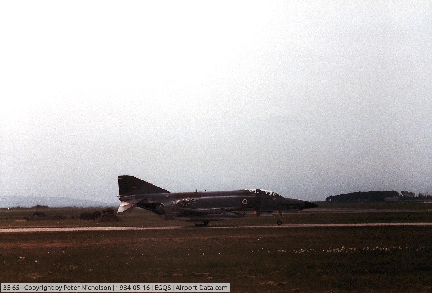 35 65, 1969 McDonnell Douglas RF-4E Phantom II C/N 4149, RF-4E Phantom of AKG-52 awaiting clearance to join the active runway at RAF Lossiemouth in May 1984.