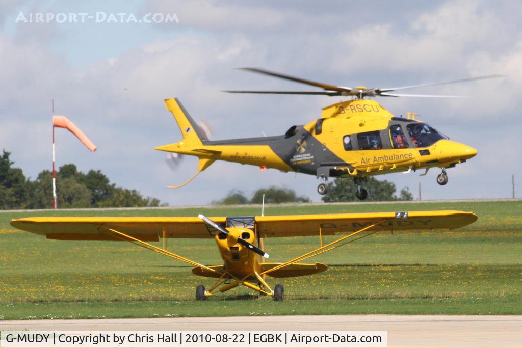 G-MUDY, 1957 Piper PA-18-150 Super Cub C/N 18-5352, with the Warwickshire & Northamptonshire Air Ambulance Agusta A109E departing