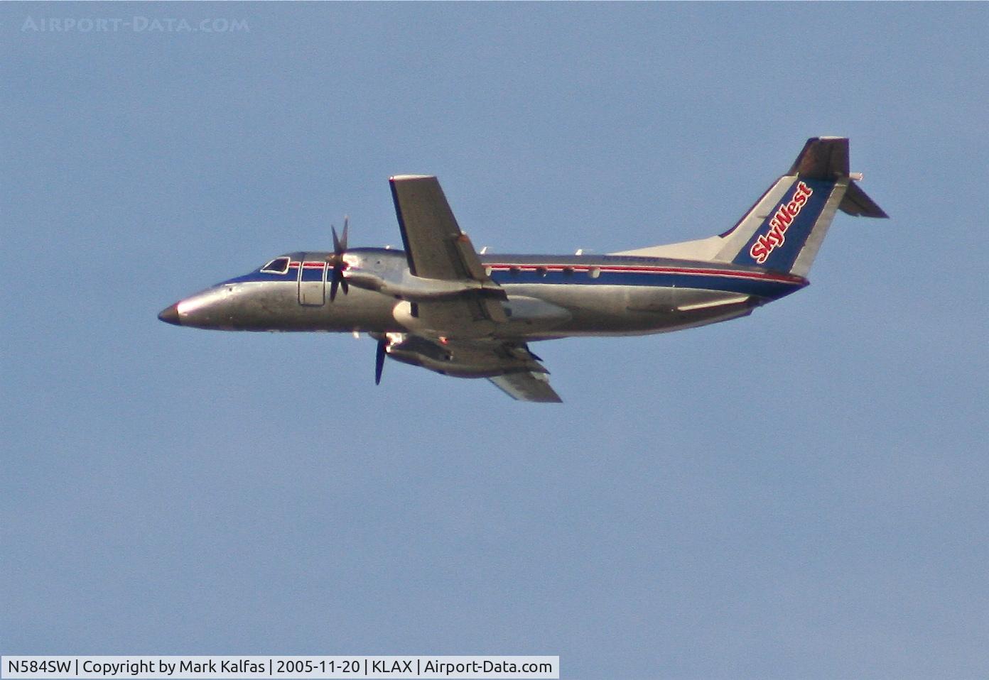 N584SW, 1999 Embraer EMB-120ER Brasilia C/N 120352, SkyWest Airlines Embraer EMB-120ER, 25R departure KLAX.