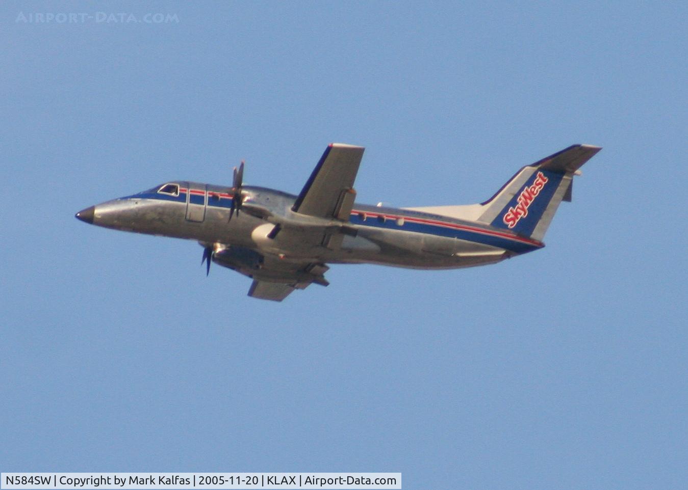 N584SW, 1999 Embraer EMB-120ER Brasilia C/N 120352, SkyWest Airlines Embraer EMB-120ER, N584SW 25R departure KLAX.