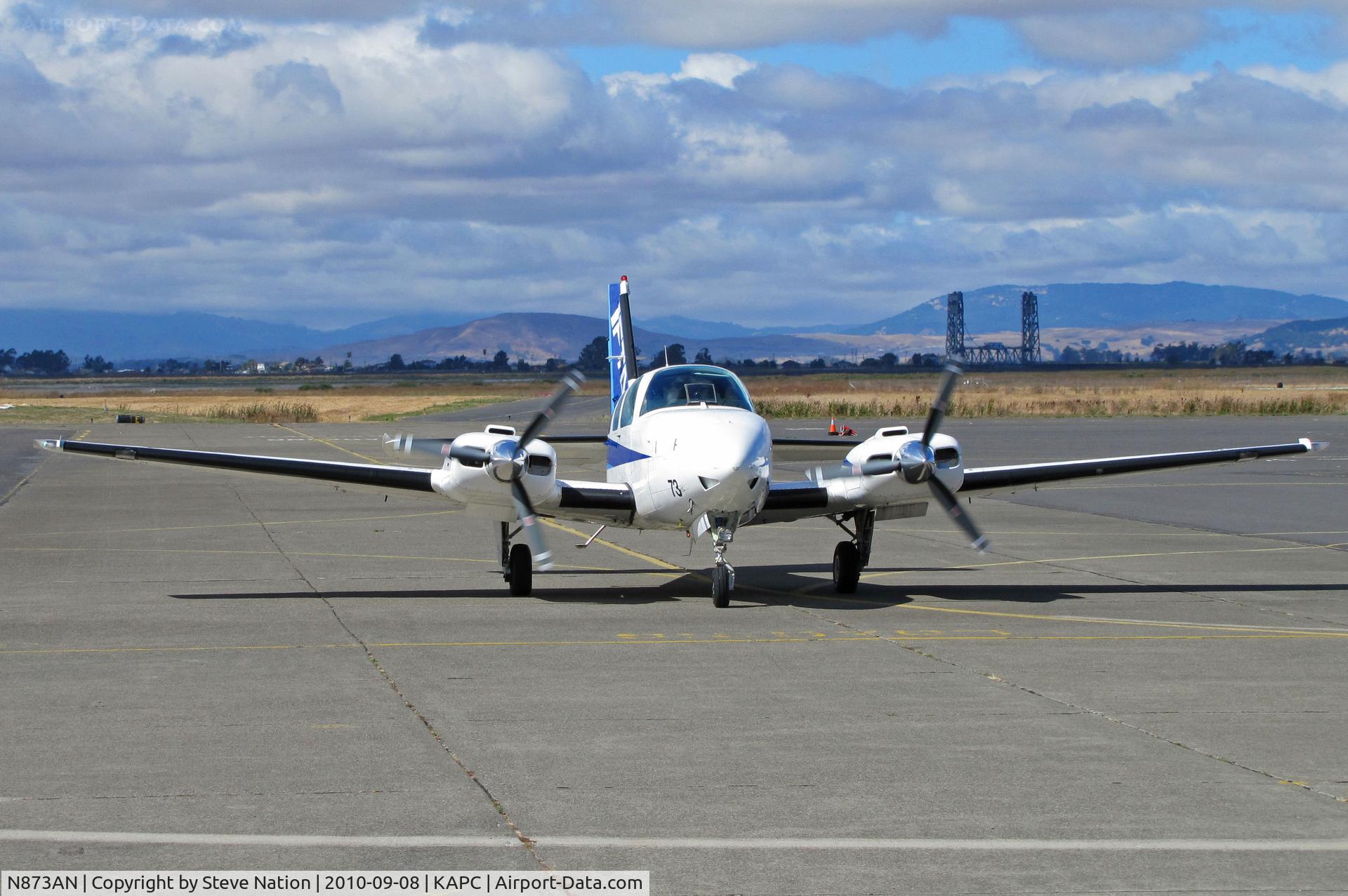 N873AN, 1993 Beech 58 Baron C/N TH-1680, IFTA Beech 58 taxis in to Bridgeport FS ramp with Napa River bridge in background - 1st time I've seen it in down position!