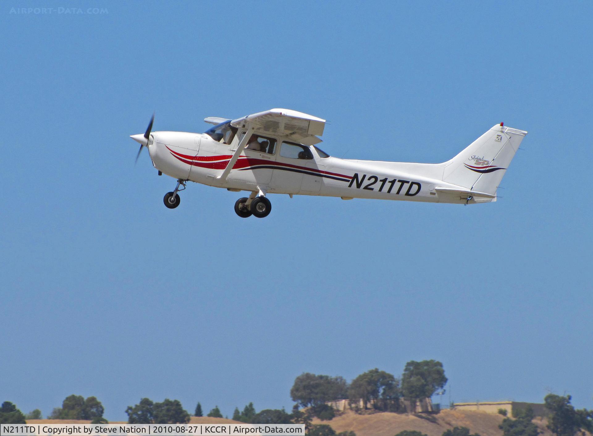 N211TD, 2000 Cessna 172S C/N 172S8524, Locally-based 2000 Cessna 172S climbs out from RWY19L at Buchanan Field with oak hillside in background
