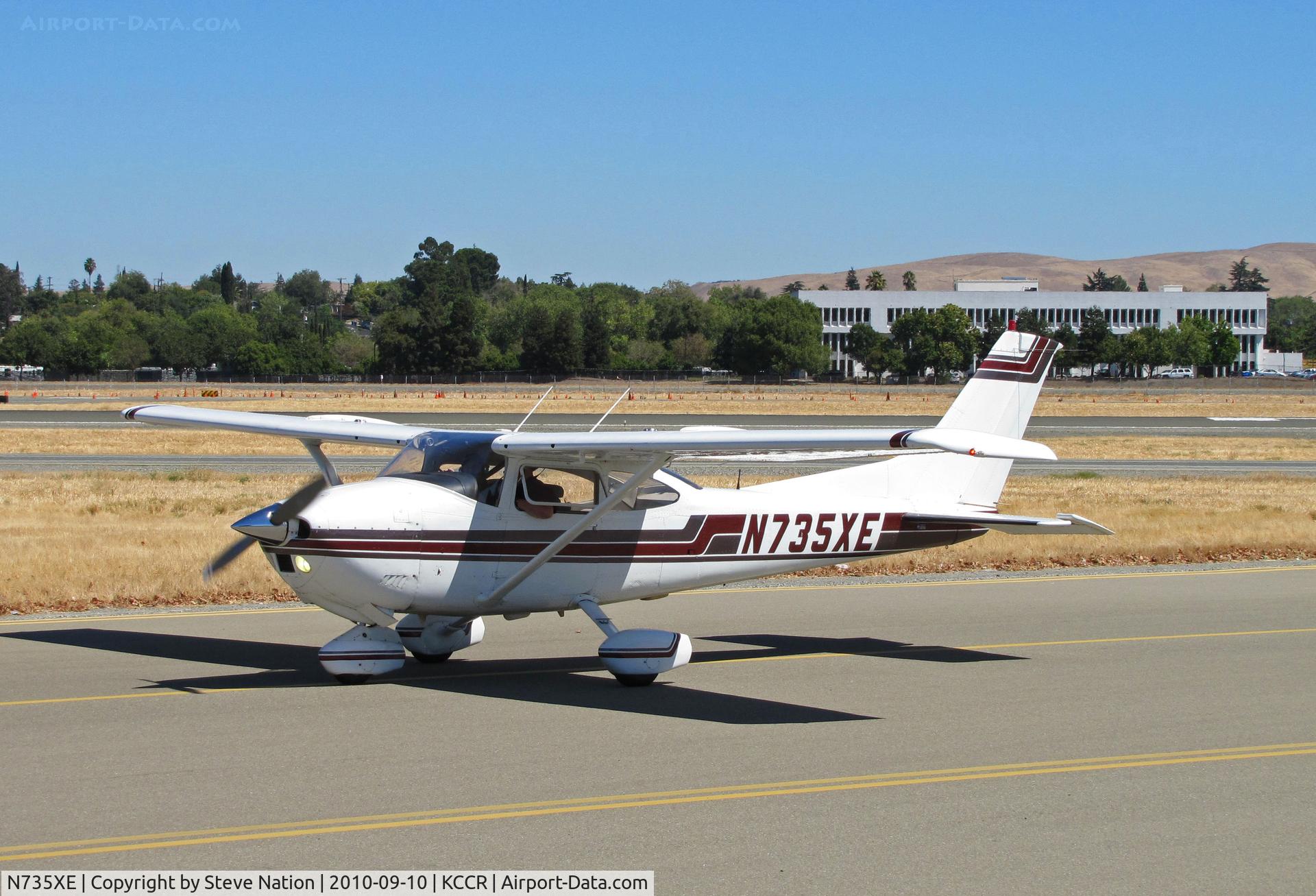 N735XE, 1977 Cessna 182Q Skylane C/N 18265760, Locally-based 1977 Cessna 182Q passing public viewing area on way to RWY1R