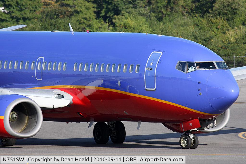 N751SW, 1999 Boeing 737-7H4 C/N 29803, Southwest Airlines N751SW (FLT SWA3056) on taxiway Echo turning onto taxiway Charlie after arrival from Jacksonville Int'l (KJAX) on RWY 5. The reflections on the side of the aircraft are mesmerizing.