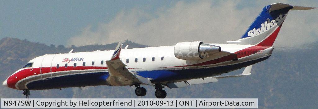 N947SW, 2003 Bombardier CRJ-200LR (CL-600-2B19) C/N 7786, On final over the outer fence for runway 26R