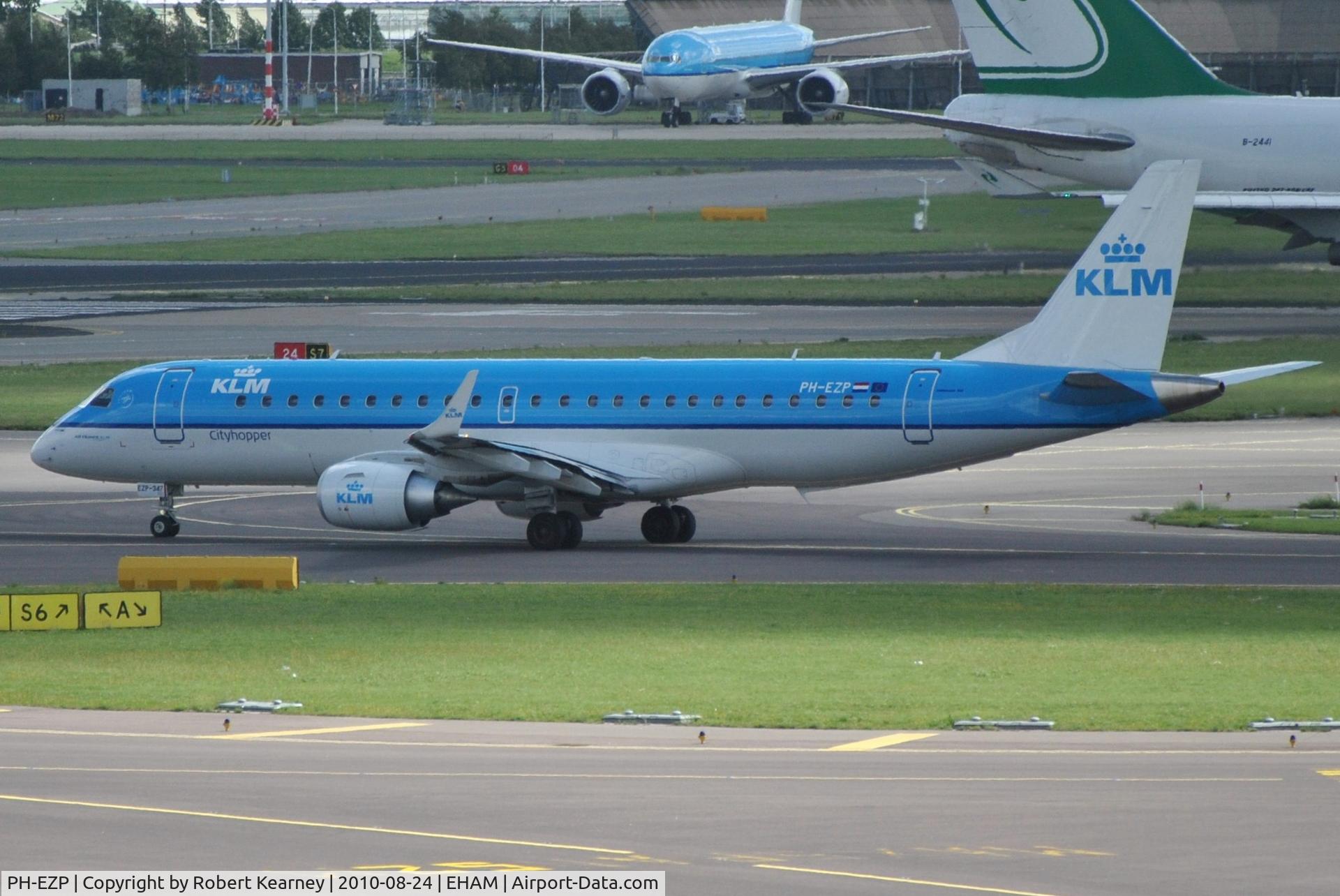 PH-EZP, 2010 Embraer 190LR (ERJ-190-100LR) C/N 19000347, KLM cityhopper taxiing for take off with a Jade Cargo B747 rolling behind