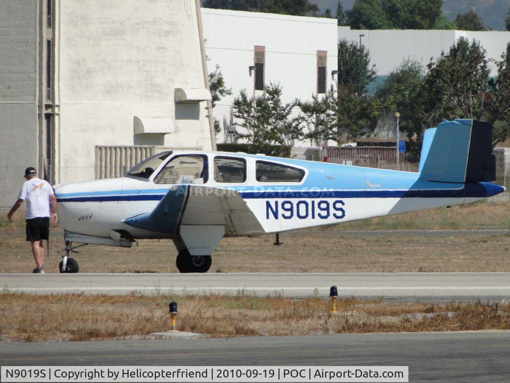 N9019S, 1965 Beech S35 Bonanza C/N D-7949, Pilot walking around the front of the aircraft to survey the damage, while traffic is diverted to runway 26R