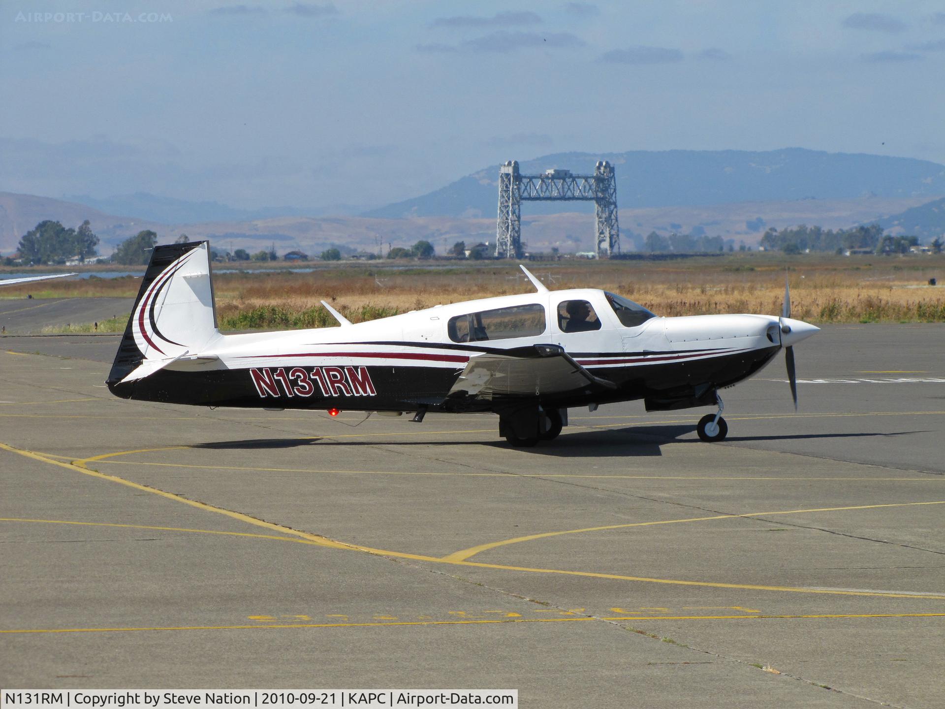 N131RM, 1996 Mooney M20M Bravo C/N 27-0218, Very sharp 1996 Mooney M20M arriving on visitors ramp at Napa County Airport, CA (KAPC) from University Airport, Davis, CA (KEDU) with Napa River RR bridge in background