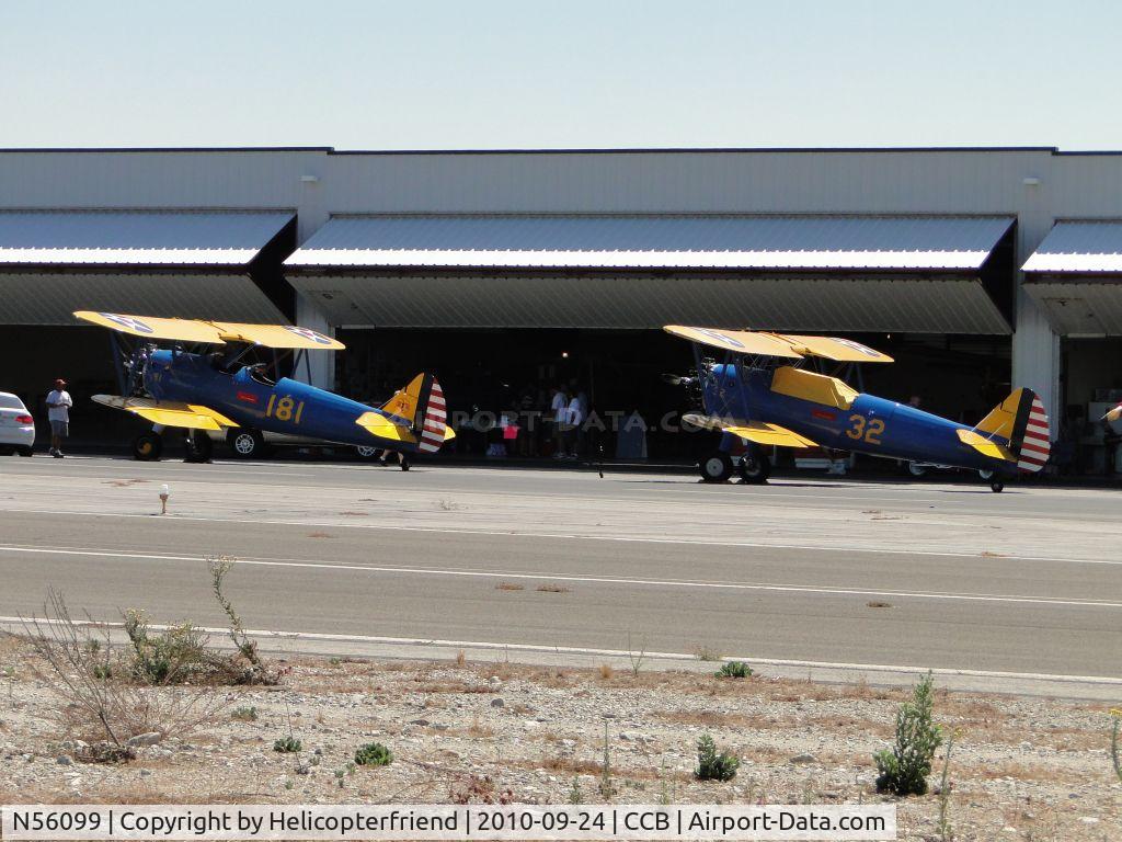 N56099, 1941 Boeing A75N1 C/N 75-873, N56099 and N4432Q parked in front of a hanger for display