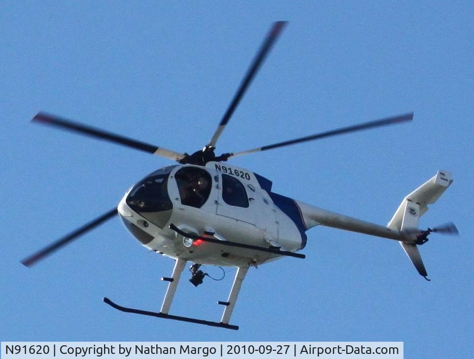 N91620, 1996 McDonnell Douglas 369E C/N 0529E, Exotic 5 blade Homeland Security seen flying South over Ocean Beach Pier, San Diego, CA.