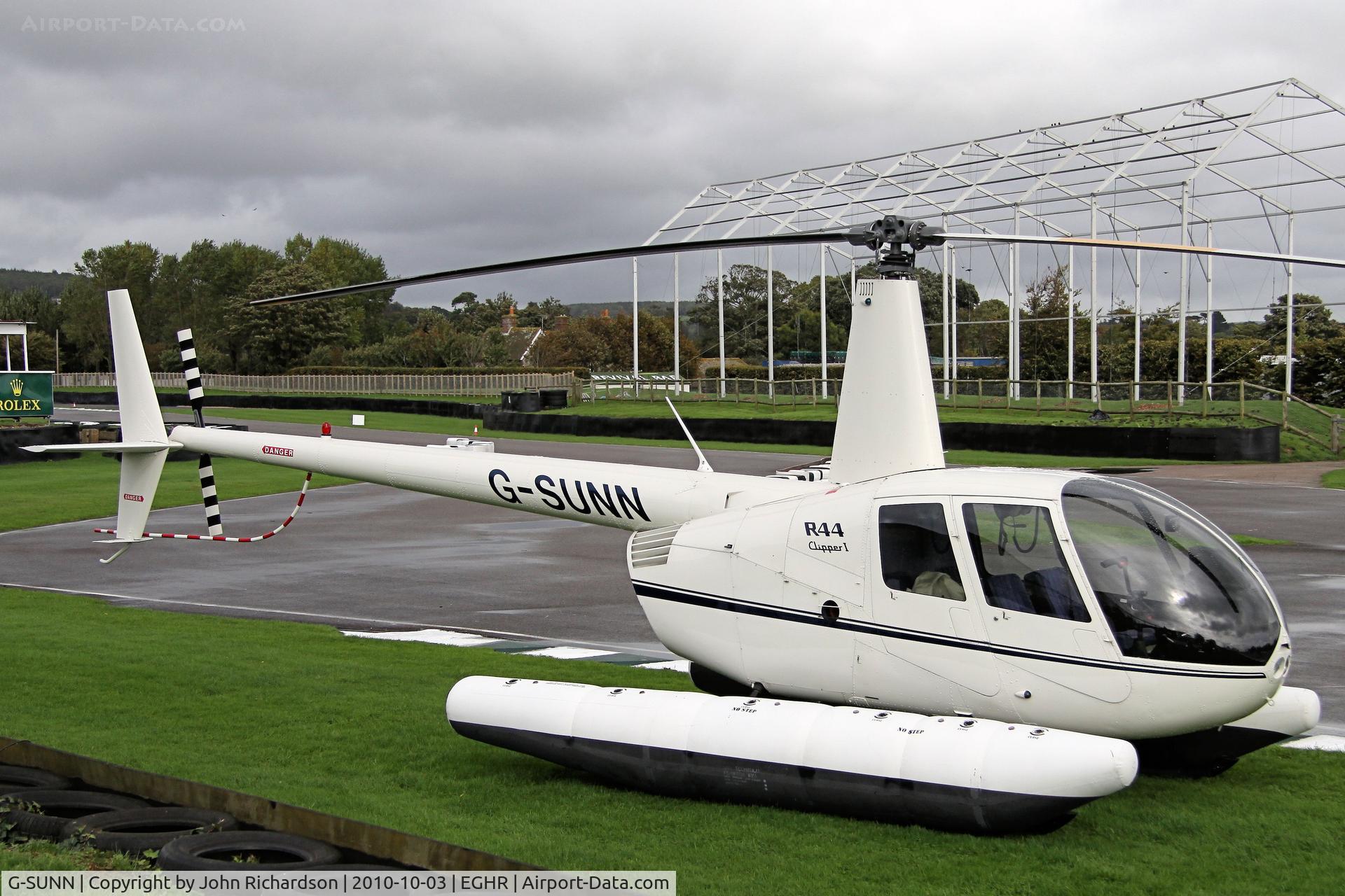 G-SUNN, 2004 Robinson R44 Clipper C/N 1367, Parked on the edge of the Motor Circuit by the Chicane