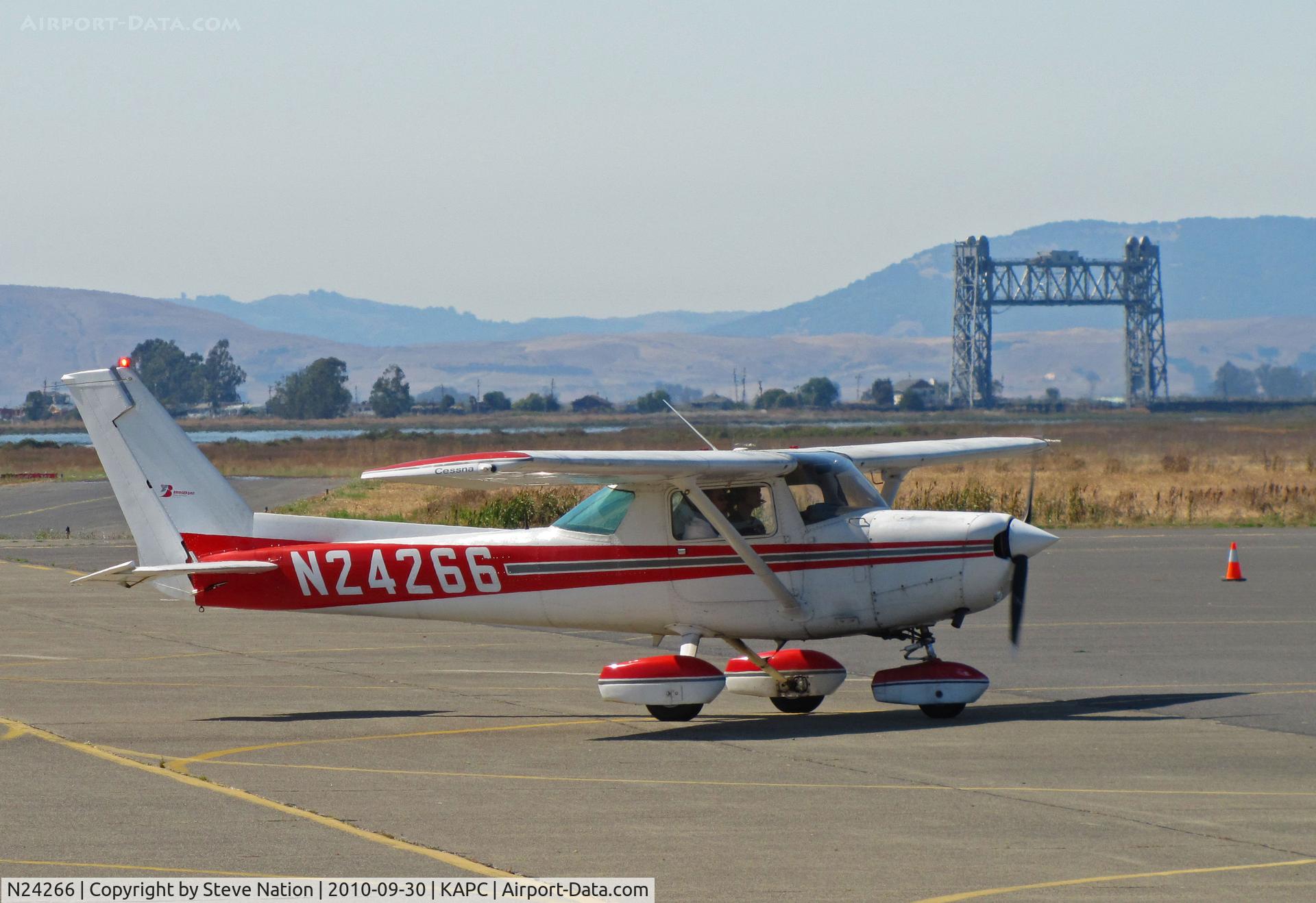 N24266, 1977 Cessna 152 C/N 15280185, Bridgeford FS 1977 Cessa 152 taxiing in with Napa River RR bridge in background