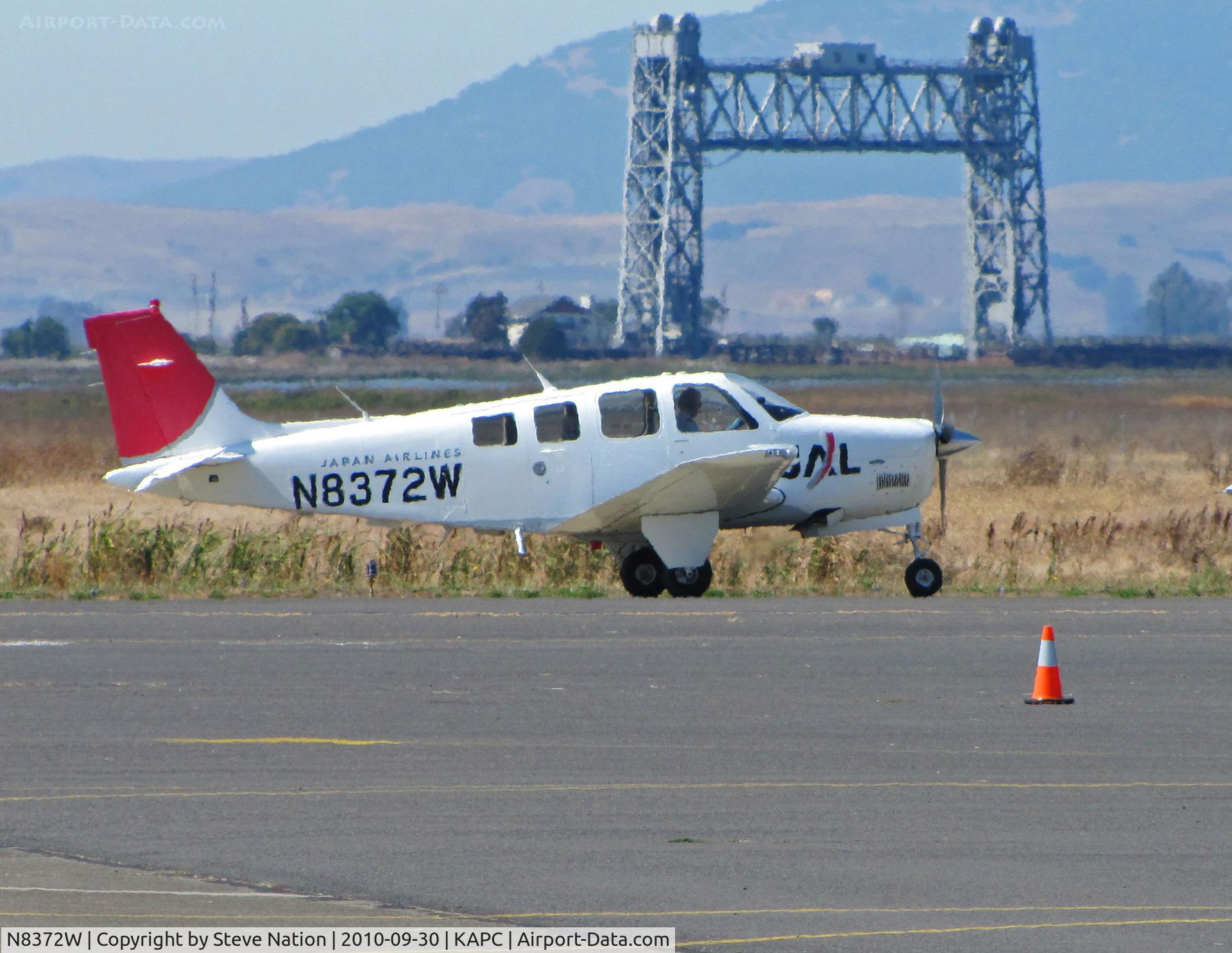 N8372W, 2004 Raytheon Aircraft Company A36 Bonanza C/N E-3573, Japan Airlines A36 taxiing by Napa River RR bridge