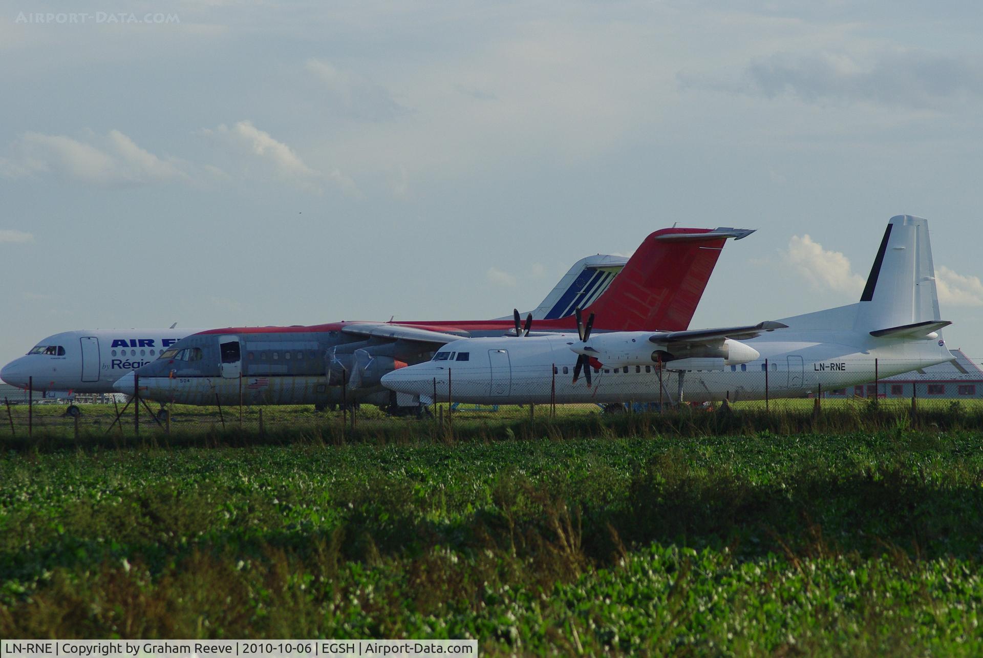 LN-RNE, 1990 Fokker 50 C/N 20179, Parked at Norwich with other aircraft on the apron.