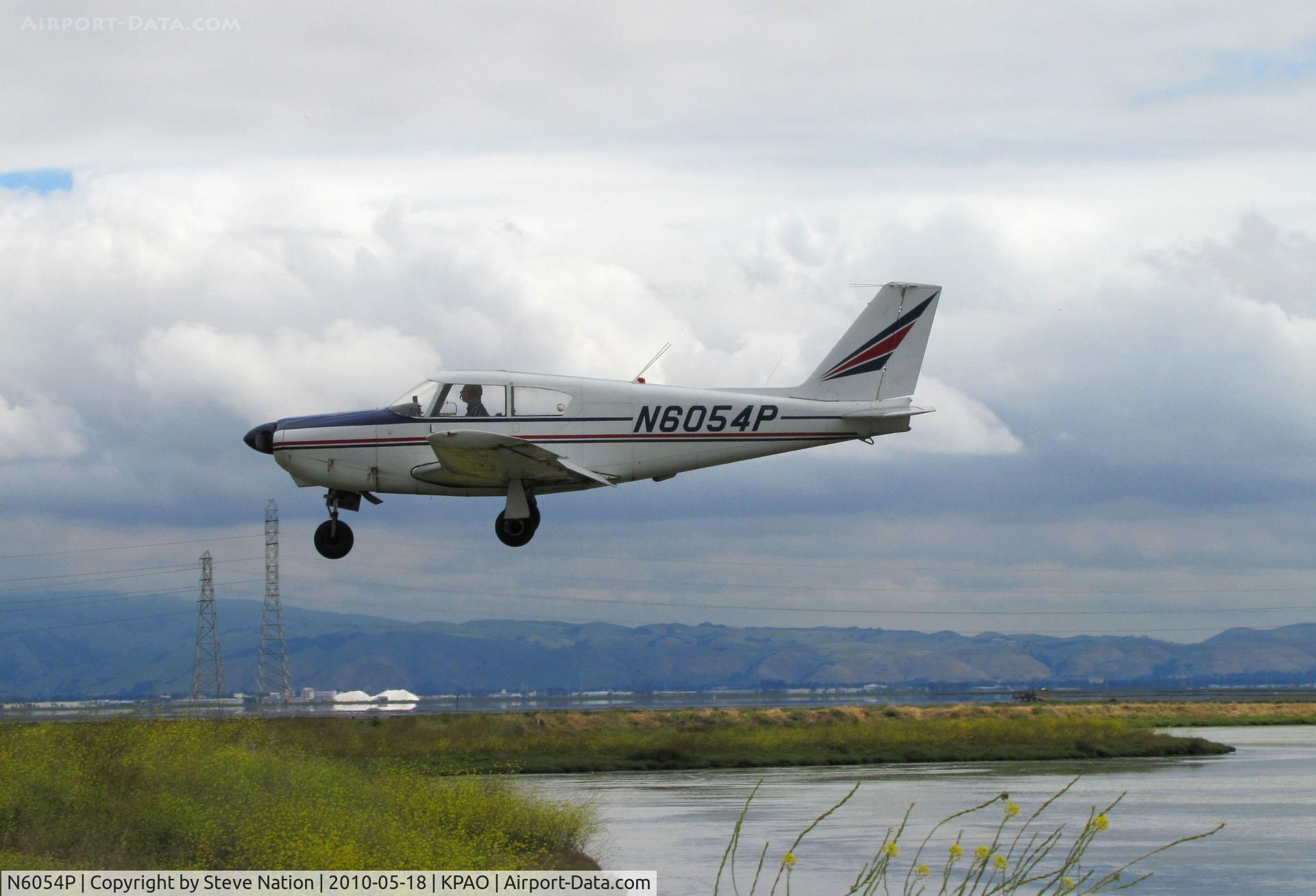 N6054P, 1959 Piper PA-24 C/N 24-1150, 1959 Piper PA-24 Comanche over the wetlands on final to Palo Alto, CA - nice lighting!