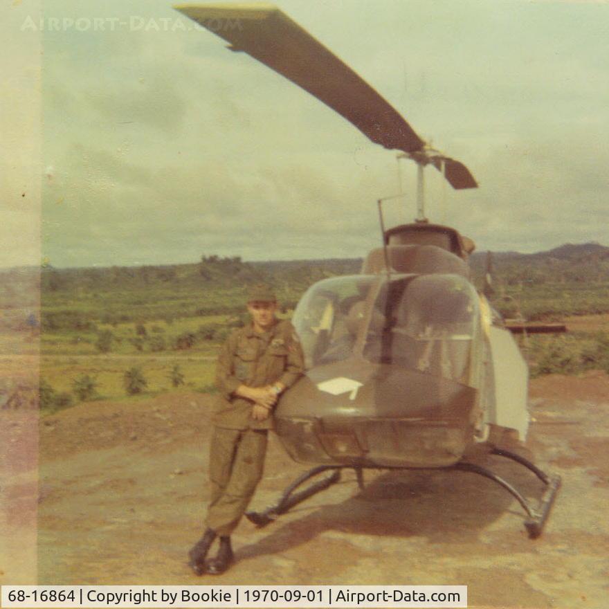 68-16864, 1968 Bell OH-58A Kiowa C/N 40178, Sgt. West and 864 setting outside an engineering compound in Viet Nam. The copilot's armor plate has been left hanging open.  Oh, she looks so new!