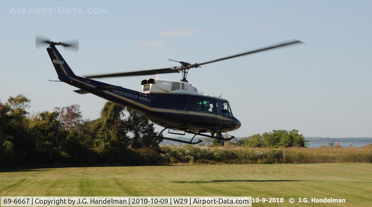 69-6667, 1969 Bell UH-1N Iroquois C/N 31073, heading away over Chesapeake Bay to Andrews AFB