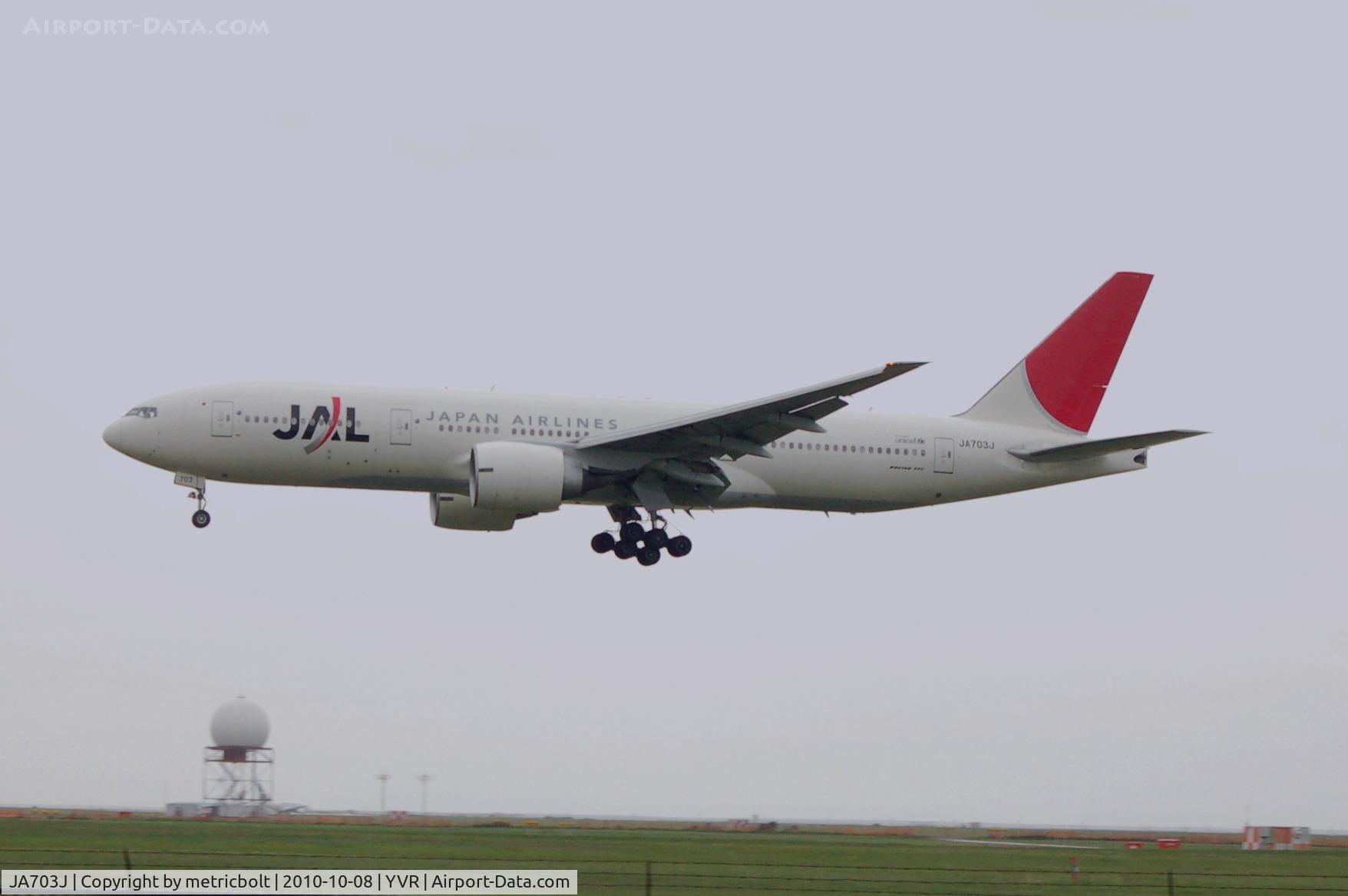 JA703J, 2003 Boeing 777-246/ER C/N 32891, Landing at YVR on a wet rainy morning.